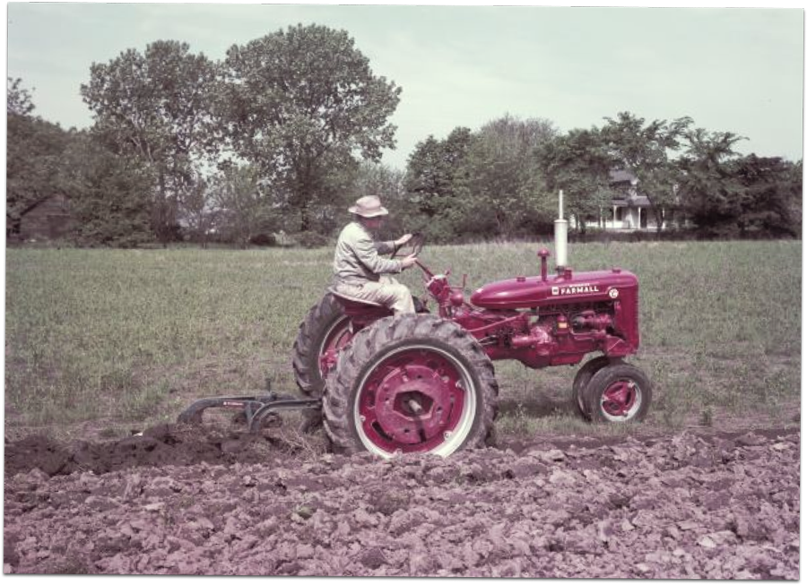 Farmer tilling field with a 1951 Farmall Super C